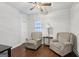 Bedroom featuring seating area, fan and dark hardwood floors at 411 Johnson Rd, Locust Grove, GA 30248