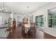Bright dining room with wood floors, stylish chandelier, and access to screened porch at 411 Johnson Rd, Locust Grove, GA 30248