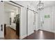 Bright entryway featuring hardwood floors, neutral walls, and a barn door to the kitchen at 411 Johnson Rd, Locust Grove, GA 30248