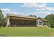 Back of house featuring a screened in porch, siding, green lawn, and cloudy sky at 411 Johnson Rd, Locust Grove, GA 30248