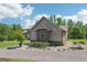 Well-maintained home with stone accents, gray siding, and a lush, landscaped yard at 411 Johnson Rd, Locust Grove, GA 30248