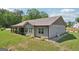 Exterior view of the house with a screened-in porch and manicured lawn at 411 Johnson Rd, Locust Grove, GA 30248