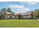 An eye-level shot shows the home's facade, gray siding, and well-maintained lawn at 411 Johnson Rd, Locust Grove, GA 30248