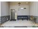 Covered front porch featuring stone accents, a bench, and a well-lit entryway at 411 Johnson Rd, Locust Grove, GA 30248