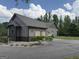 Spacious garage with multiple bays, stone accents, and plenty of parking space at 411 Johnson Rd, Locust Grove, GA 30248