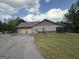Detached garage with multiple bays, a side entrance, and ample parking space at 411 Johnson Rd, Locust Grove, GA 30248