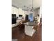 A modern kitchen features white cabinets, dark countertops, and an island with bar seating at 411 Johnson Rd, Locust Grove, GA 30248