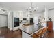 Modern kitchen features white cabinetry, granite countertops, and a center island with seating at 411 Johnson Rd, Locust Grove, GA 30248
