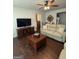 Cozy living room with neutral paint, ceiling fan, dark hardwood floors, and comfortable seating at 411 Johnson Rd, Locust Grove, GA 30248