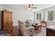 Cozy living room with hardwood floors, a ceiling fan, and plenty of natural light from the windows at 411 Johnson Rd, Locust Grove, GA 30248