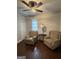Cozy living room with hardwood floors, two armchairs, a ceiling fan, and natural light at 411 Johnson Rd, Locust Grove, GA 30248