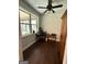 Functional home office nook with natural light from a large window, hardwood floors and ceiling fan at 411 Johnson Rd, Locust Grove, GA 30248