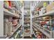 Walk-in pantry provides lots of storage with shelves filled with food and containers at 411 Johnson Rd, Locust Grove, GA 30248