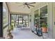 Covered porch perfect for outdoor relaxation, featuring a ceiling fan and garden view at 411 Johnson Rd, Locust Grove, GA 30248