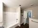 Bathroom featuring updated fixtures, white tiled shower and wood floors at 4487 Greenleaf Sw Cir, Atlanta, GA 30331
