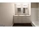 Modern bathroom featuring double sinks with granite countertops, wood floors and new fixtures at 4487 Greenleaf Sw Cir, Atlanta, GA 30331