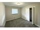 This bedroom features neutral paint and carpet, a window with blinds, and a double door closet at 4487 Greenleaf Sw Cir, Atlanta, GA 30331