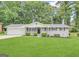 Charming single-story home with a well-manicured lawn, painted brick, and a cozy front porch at 4487 Greenleaf Sw Cir, Atlanta, GA 30331