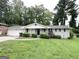 Single story home features a well kept lawn, painted brick and a cozy front porch at 4487 Greenleaf Sw Cir, Atlanta, GA 30331