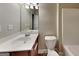 A bathroom features a white toilet and single vanity with a mirror, cabinet, and lighting at 330 Bentleigh Station Dr, Acworth, GA 30101
