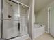 Bathroom features a tub and a shower with glass doors at 330 Bentleigh Station Dr, Acworth, GA 30101
