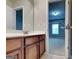 A bathroom features a single vanity with cabinet, large mirror and doorway to a bedroom at 330 Bentleigh Station Dr, Acworth, GA 30101