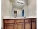 A bathroom features a double vanity, large mirror, dark cabinetry, and modern lighting at 330 Bentleigh Station Dr, Acworth, GA 30101