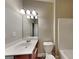 This bathroom features a modern vanity, a well-lit mirror, and a toilet at 330 Bentleigh Station Dr, Acworth, GA 30101