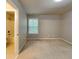 This is a neutrally decorated bedroom with carpet, paint and an ensuite bathroom at 330 Bentleigh Station Dr, Acworth, GA 30101