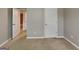 This bedroom features neutral carpet and paint, and access to another room at 330 Bentleigh Station Dr, Acworth, GA 30101