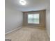 Bedroom with neutral paint, carpet and a window with blinds for ample privacy at 330 Bentleigh Station Dr, Acworth, GA 30101