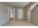 A carpeted bedroom features neutral walls, a white door, and a doorway to an additional space at 330 Bentleigh Station Dr, Acworth, GA 30101