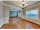 Spacious dining room featuring hardwood floors, decorative trim, and elegant chandelier at 330 Bentleigh Station Dr, Acworth, GA 30101