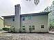 Home's exterior shows horizontal siding, a large chimney, and mature trees at 330 Bentleigh Station Dr, Acworth, GA 30101