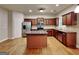 Well-lit kitchen features an island, stainless steel appliances, and stained cabinets at 330 Bentleigh Station Dr, Acworth, GA 30101