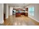 Open-concept kitchen area with wood floors, stainless appliances and ample counter space at 330 Bentleigh Station Dr, Acworth, GA 30101