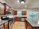 Well-lit kitchen featuring stainless steel appliances, wooden cabinets, and granite countertops at 330 Bentleigh Station Dr, Acworth, GA 30101
