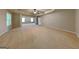 Large primary bedroom features a tray ceiling, ceiling fan, and large windows at 330 Bentleigh Station Dr, Acworth, GA 30101