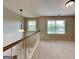 Upstairs landing area with natural light and neutral carpeting at 330 Bentleigh Station Dr, Acworth, GA 30101