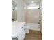 This bathroom has white cabinets, black hardware, and a tiled shower and bath at 214 Wet Wood Ct # 26, Fairburn, GA 30213