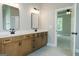 Bathroom featuring double sink vanity with black fixtures, framed mirrors and a view to the bedroom at 214 Wet Wood Ct # 26, Fairburn, GA 30213