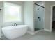 Freestanding tub and seamless glass shower are focal points in this modern bathroom at 214 Wet Wood Ct # 26, Fairburn, GA 30213