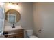 This bathroom features a wood vanity, white countertop, round mirror and black hardware at 214 Wet Wood Ct # 26, Fairburn, GA 30213