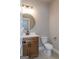 This bathroom features a wood vanity, white countertop, round mirror and black hardware at 214 Wet Wood Ct # 26, Fairburn, GA 30213