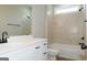 This bathroom has white cabinets, black hardware, and a tiled shower and bath at 214 Wet Wood Ct # 26, Fairburn, GA 30213