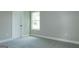 This room has a window, carpet, a door, and a neutral color scheme at 214 Wet Wood Ct # 26, Fairburn, GA 30213