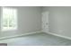 Bedroom with carpet, a window providing natural light and a white door at 214 Wet Wood Ct # 26, Fairburn, GA 30213