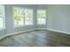 Corner bedroom with hardwood floors and natural light from two large windows at 214 Wet Wood Ct # 26, Fairburn, GA 30213