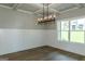 Dining room showcasing wainscoting, coffered ceiling, stylish chandelier, and hardwood floors at 214 Wet Wood Ct # 26, Fairburn, GA 30213