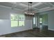 Dining room featuring wainscoting, a coffered ceiling, modern chandelier, and wood floors at 214 Wet Wood Ct # 26, Fairburn, GA 30213